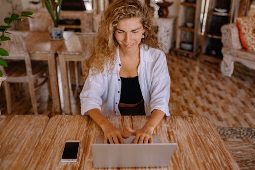 image of a digital nomad working on a laptop in a cafe