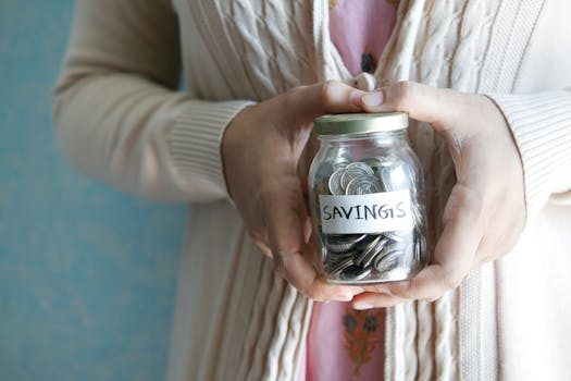 savings jar filled with coins and travel-inspired decorations