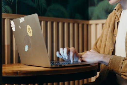 A person working on a laptop at a café