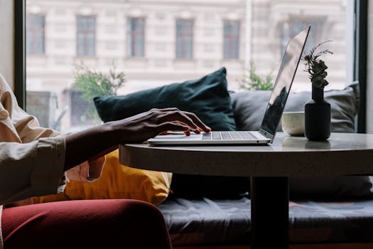 a digital nomad working on a laptop in a cozy cafe