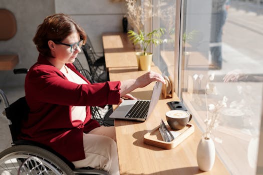 A digital nomad working on a laptop at a cafe